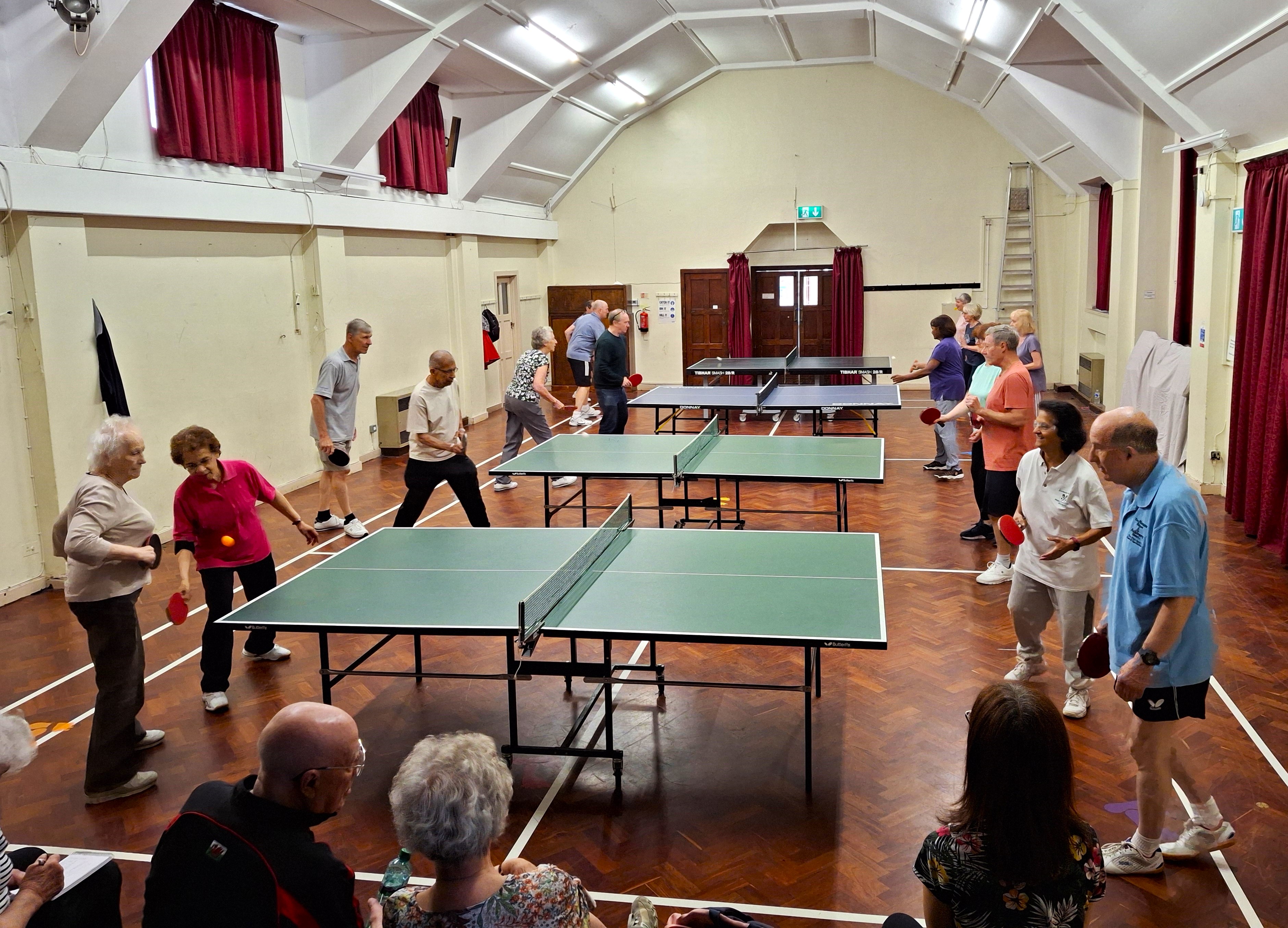 Men and women playing table tennis