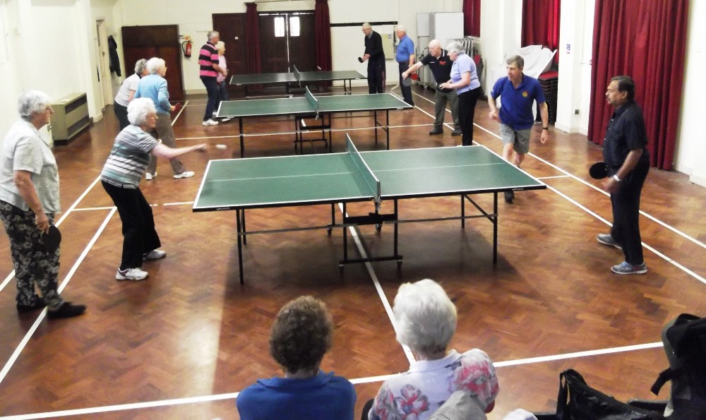 Men and women playing table tennis